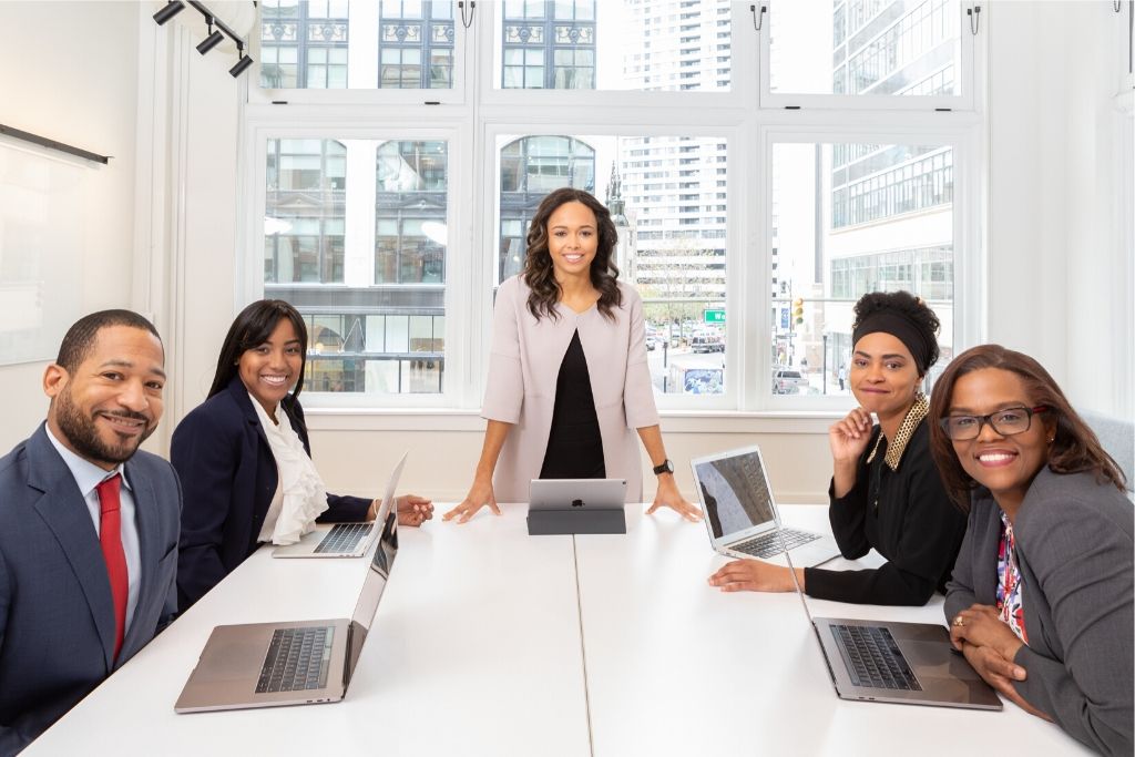 A group of professionals sit around a conference table