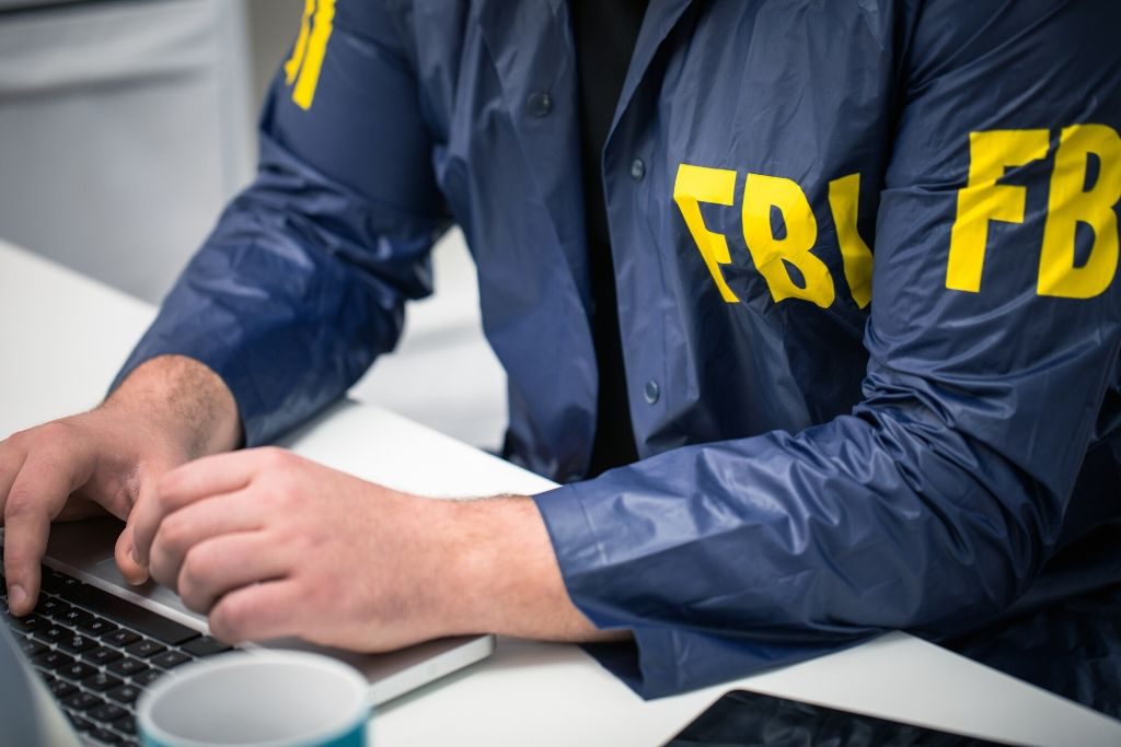 An FBI agent looking at information on their laptop