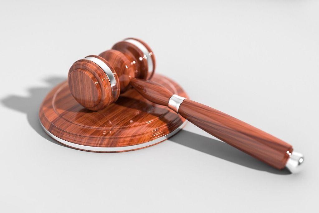 A polished gavel sits on a white table