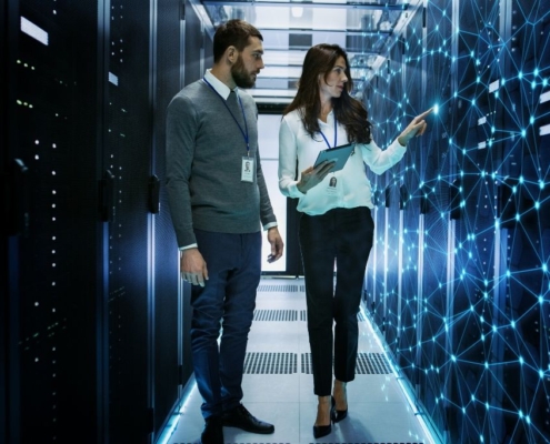 A male and female data engineer discuss collected information
