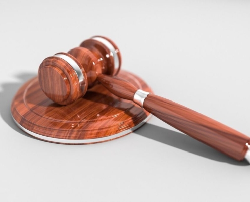 A polished gavel sits on a white table