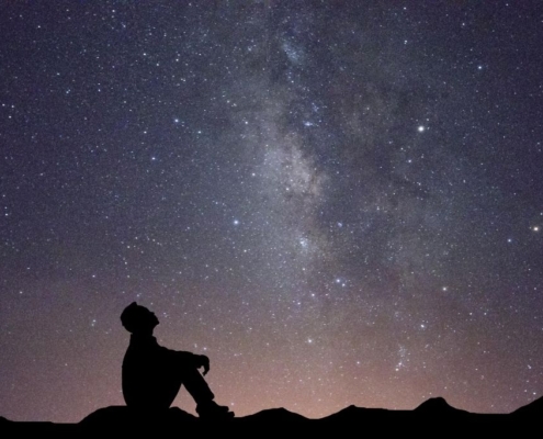 man gazes at stars