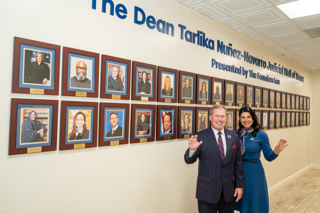 President David A. Armstrong and Dean Tarlika Nuñez-Navarro stand together smiling at the unveiling of the Judicial Wall of Honor at St. Thomas University.