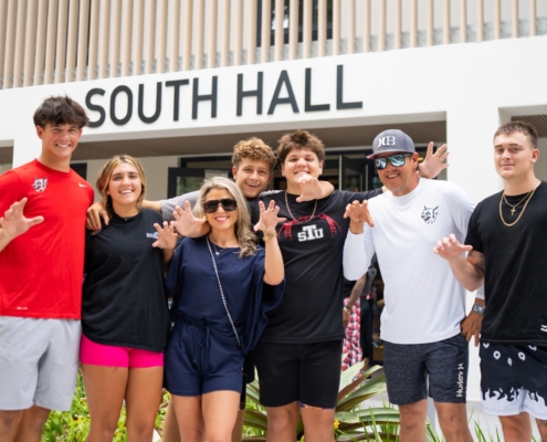 Group of STUdents posing outside of South Hall, at St. Thomas University