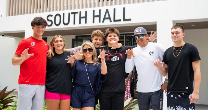 Group of STUdents posing outside of South Hall, at St. Thomas University