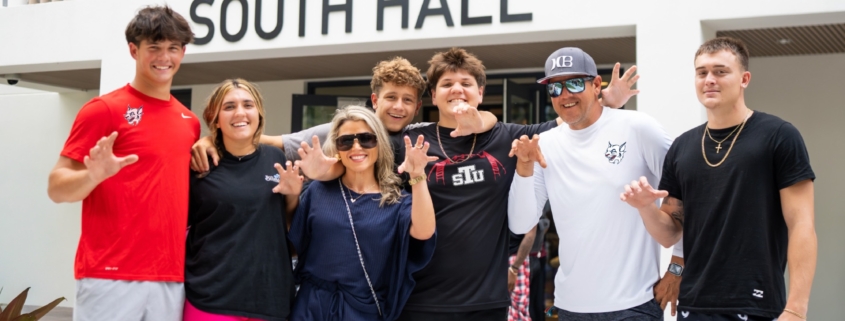 Group of STUdents posing outside of South Hall, at St. Thomas University