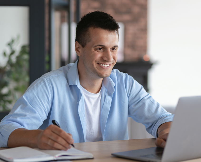 Young teacher learning online.