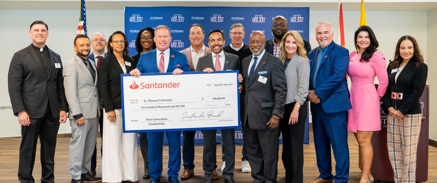 STU group holding ceremonial check from Santander US.