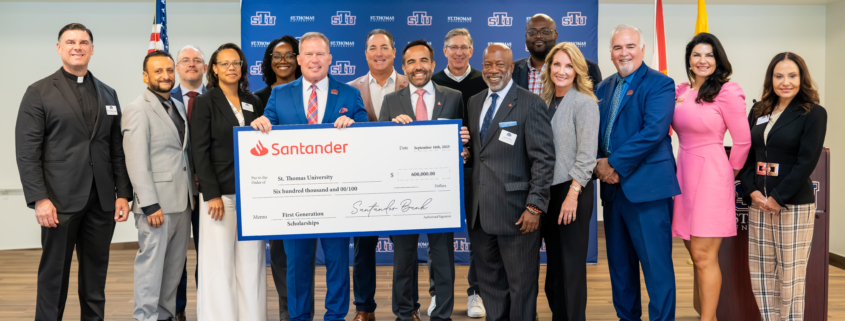 STU group holding ceremonial check from Santander US.