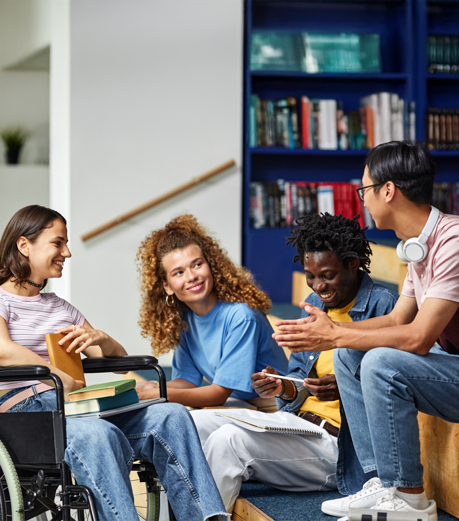 Diverse group of students chatting at a library