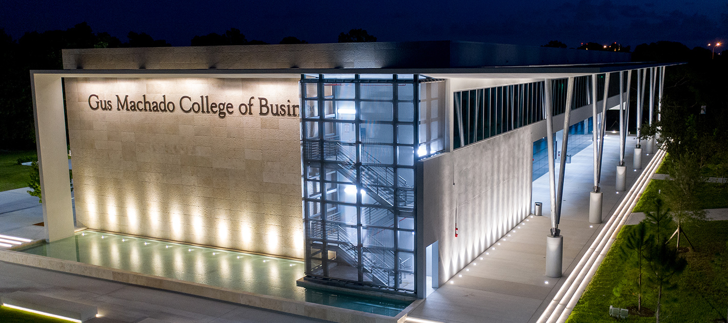 Night photo of the Gus Machado College of Business