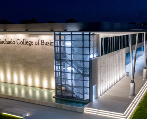 Night photo of the Gus Machado College of Business