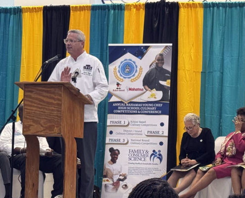 Bruce Ozga presenting on stage.