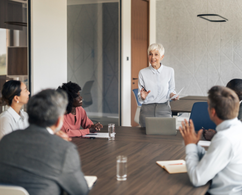 Manager leading a team discussion in a conference room, illustrating leadership and organizational collaboration.